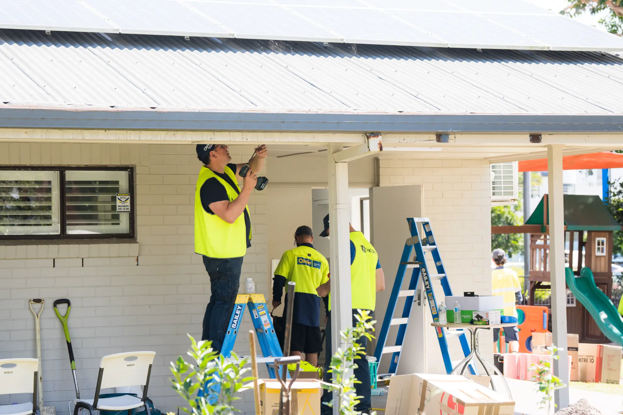 O'Brien tradies on ladders renovating the Maroochy Neighbourhood Centre during Taskforce 2025